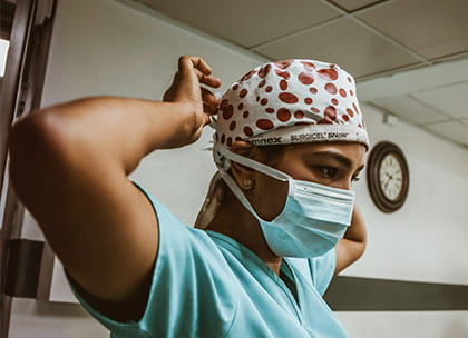 Visual of healthcare professional putting on PPE